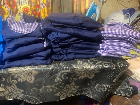 Stacks of new navy and purple gingham school uniforms